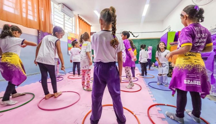 Foto de crianças em atividade com uso de bambolês em Organização Não Governamental